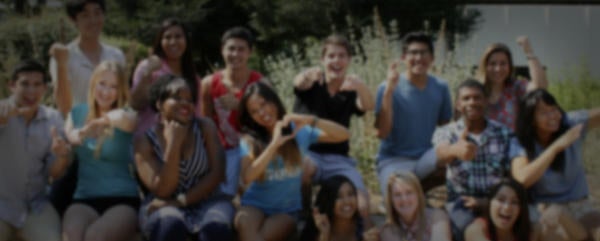 A fuzzy background of happy UCR students posing for a picture
